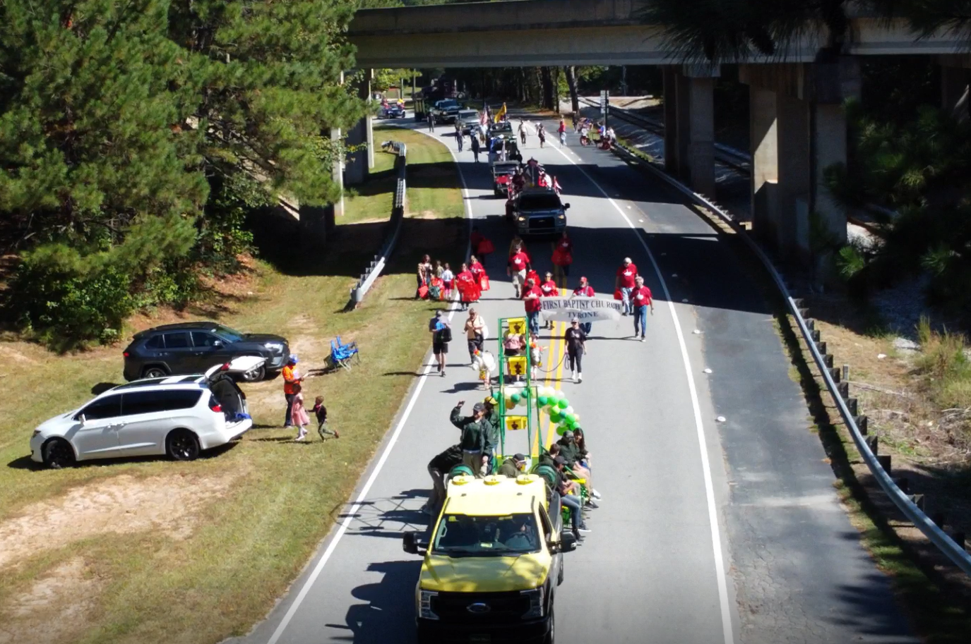 Founders Day Parade, truck, people walking in parade waving flags