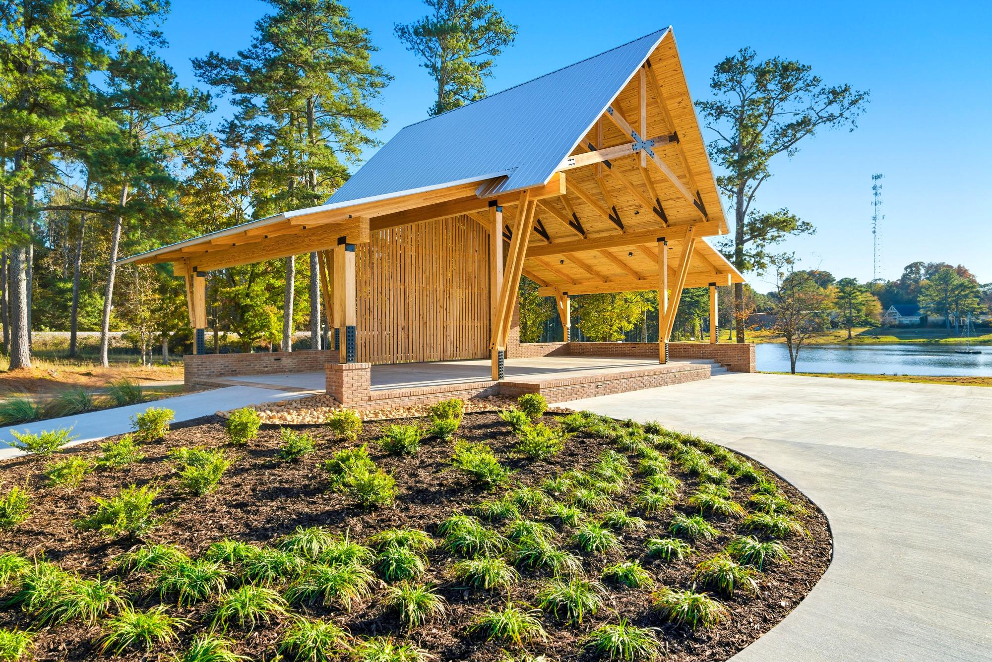 Covered wooden stage beside the lake at Shamrock Park